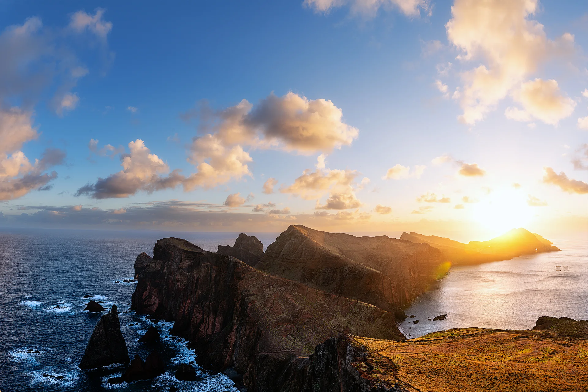 Golden sunrise over the rugged volcanic cliffs of Ponta do Furado, surrounded by the Atlantic Ocean on Madeira’s eastern coast.