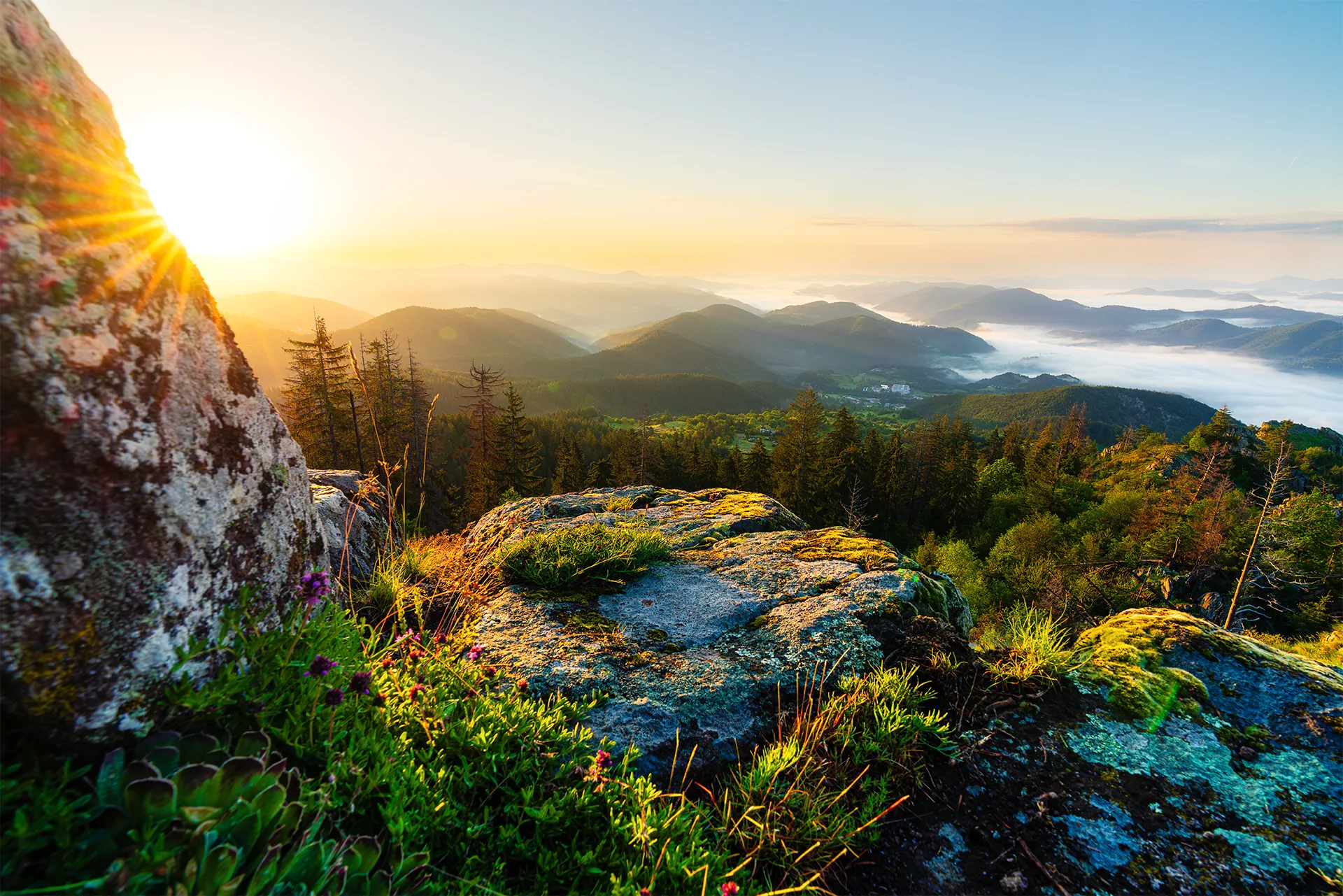 Sunrise from Kaleto above mist-filled valleys and layered mountain ridges near Smolyan.