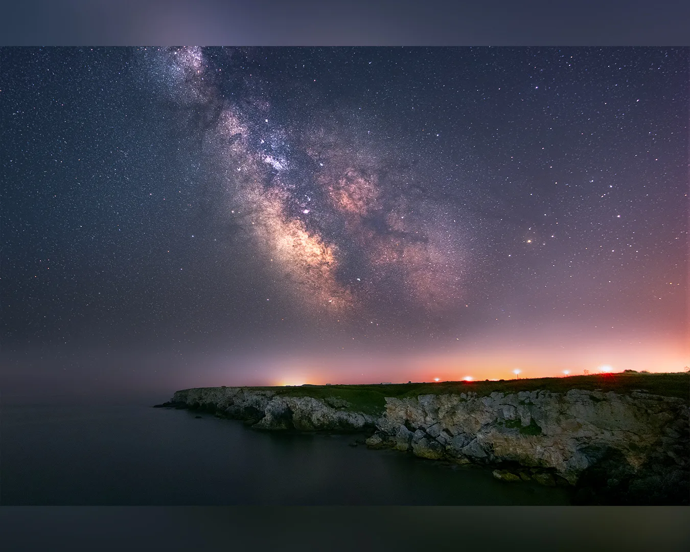Млечният път над скалистия бряг и спокойното море край Камен бряг.