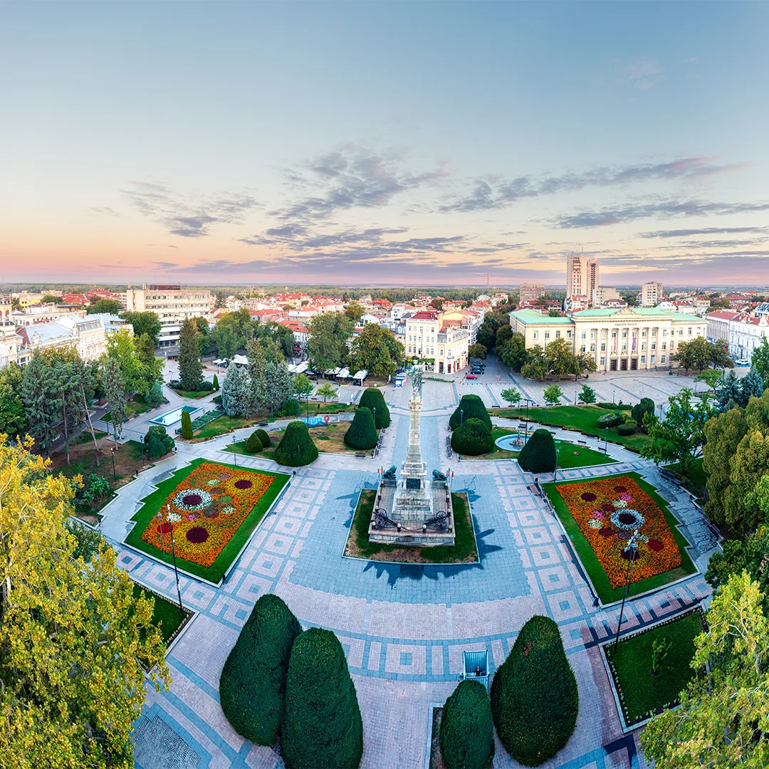 Sunrise over central Ruse, with the Monument of Liberty, landscaped gardens and the city’s historic architecture in the soft morning light.