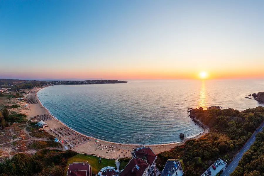 Aerial view of sunrise above Smokinya and Kavatsi Bay near Sozopol, with the sun over the Black Sea and the beach stretching along the shoreline.