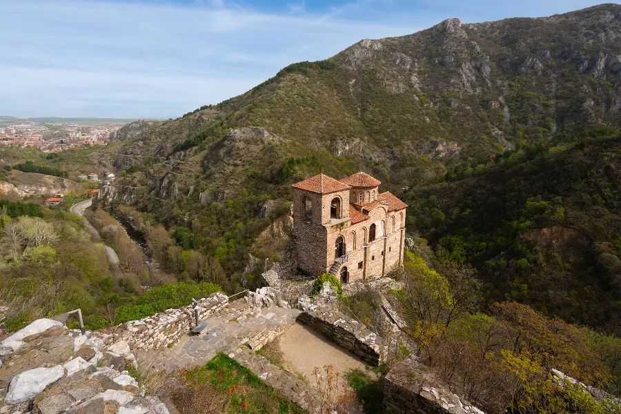 Church at Asen's Fortress on a rocky ridge above the valley, surrounded by the slopes of the Rhodope Mountains near Asenovgrad.